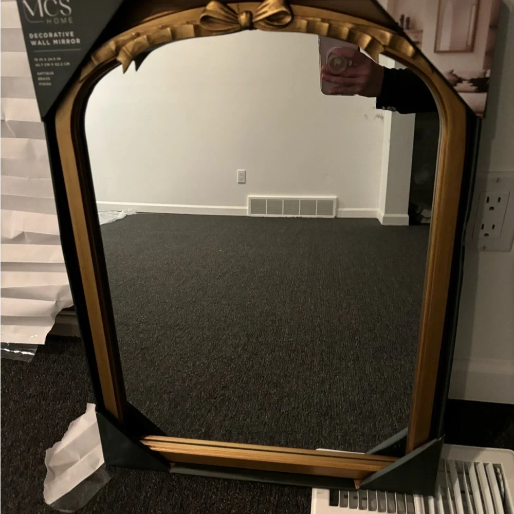 Gold bow mirror size is 18 x 24
